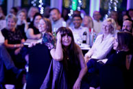 Photography of dinner reception attendee enjoying the after dinner speeker